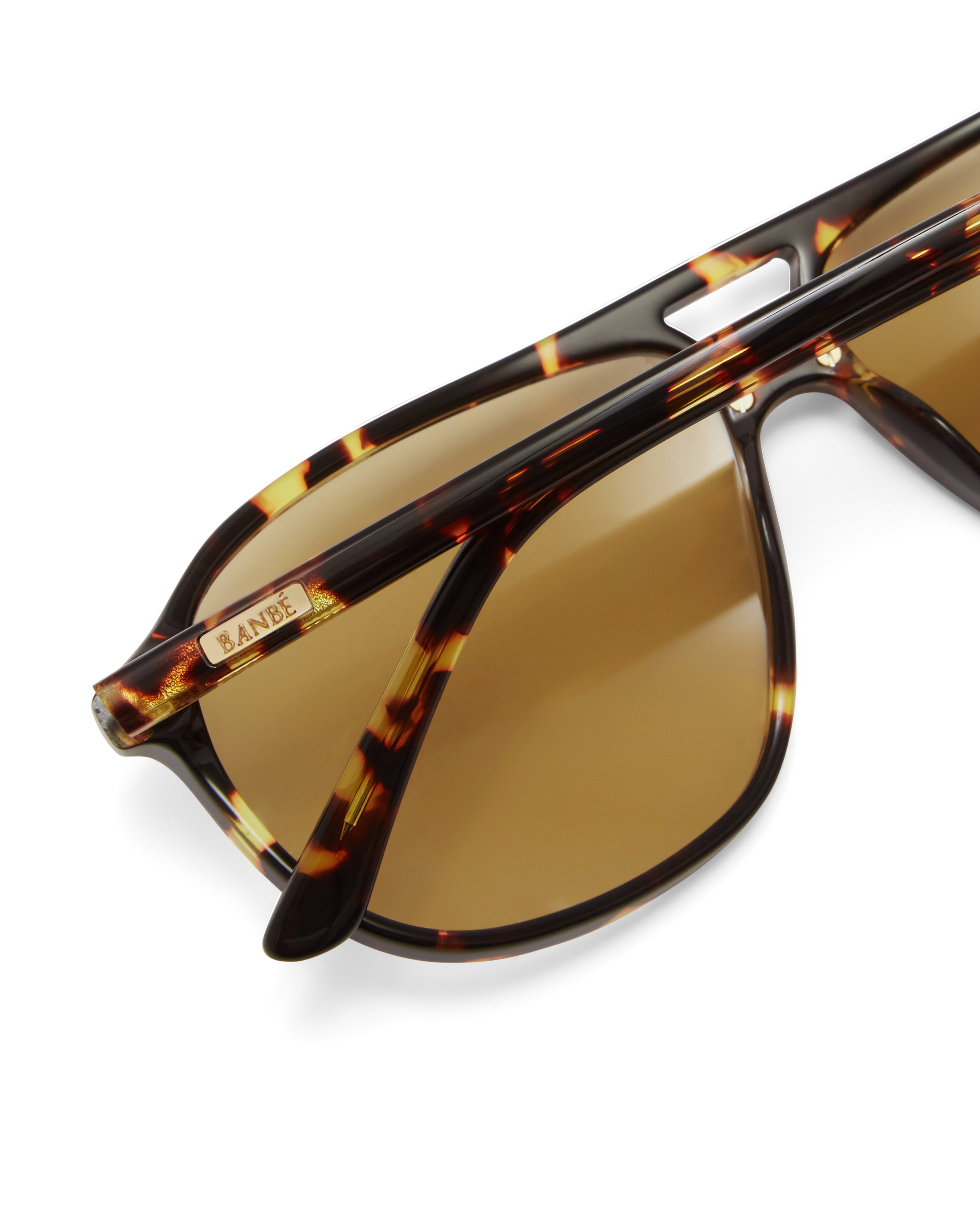 Women's aviator sunglasses in amber tort colourway featuring an oversized modified aviator silhouette with flat-top brow bar, double bridge, angular navigator-inspired shaping, and slim arms for a bold, contemporary look with full coverage.