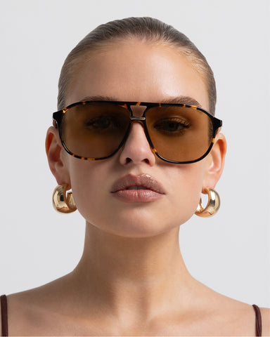 Oversized women's aviator sunglasses with a, flat-top brow bar, keyhole cut, double bridge, and slim arms.
